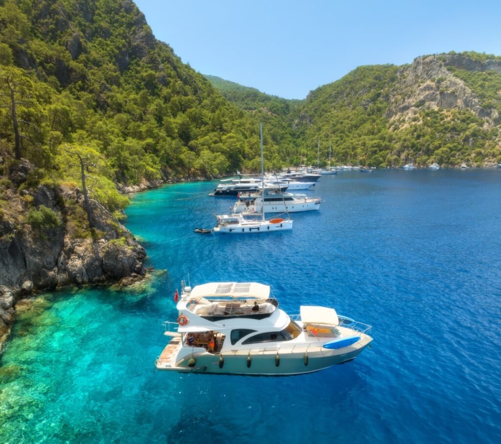 Aerial view of yachts and boats on the sea at sunset in summer