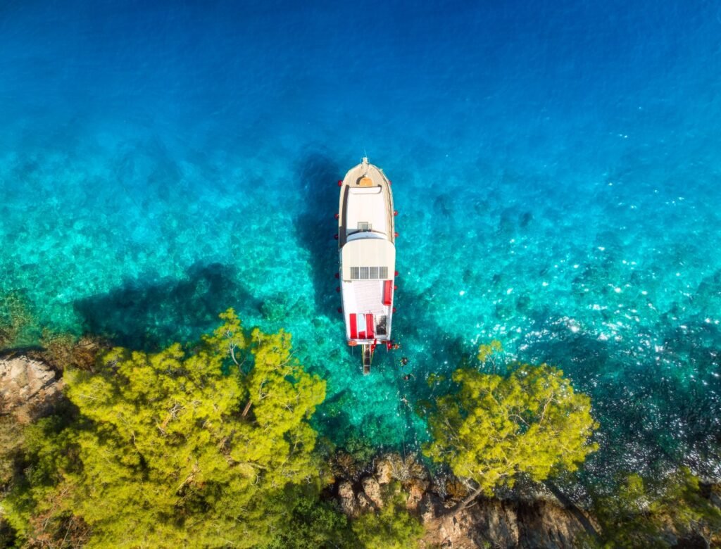 Aerial view of yachts and boats on the sea at sunset in summer